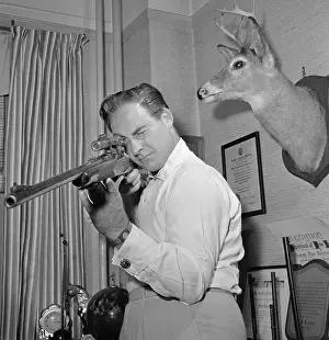 Sid Caesar Holding Rifle