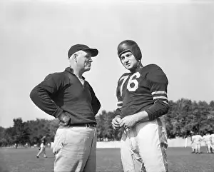 Quarterback Prints: Sid Luckman In Uniform Talking To Coach