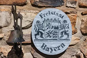 Bayern Prints: Sign Freistaat Bayern, English for Free State of Bavaria with a bell on a natural stone wall