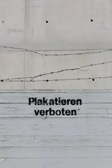 Inscription Prints: Sign Plakatieren verboten, German for no flyposting with barbed wire