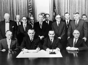 Prints of (Original Caption) 11/30/61-Washington, D.C.: Vice President Lyndon B. Johnson and officials of 12 major defense contractors signed pledges today assuring equal employment oppurtunity to Negroes LBJ Unveiled: Iconic Moments from a Presidential Era: Signing Pledge For Equal Employment
