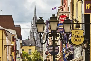 County Cork, Ireland Gallery: Signs and lights in a street scene in downtown Cork, with Holy Trinity Church in the background