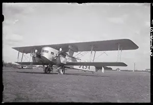 Biplane Prints: Sikorsky Commercial Airplane Parked in a Field