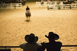 Images Dated 16th April 2016: Silhouette of cowboys at indoor rodeo