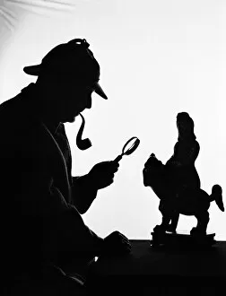 Silhouette of man wearing deerstalker, dressed as Sherlock Holmes. (Photo by H