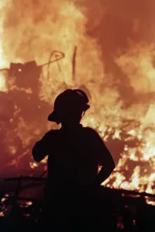 Marina Prints: Silhouetted Fireman Watching Fire