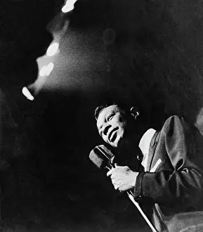 Singer Nat King Cole Holding Microphone