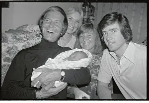 Singer Pat Boone Holding Grandson