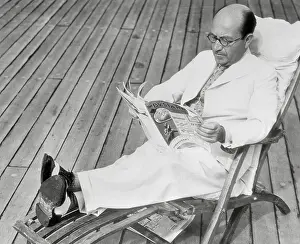 Sir Montague Burton Reading Magazine in Deck Chair