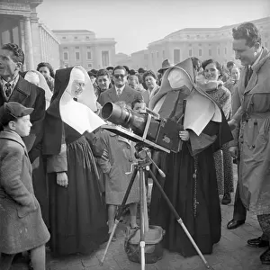A Sister Looking Through a Long Range Camera