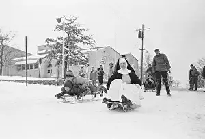 Habit Prints: Sister Monica Rides a Sled with Children