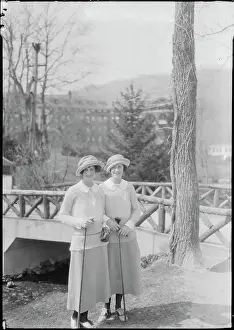 Sisters Holding Golf Clubs