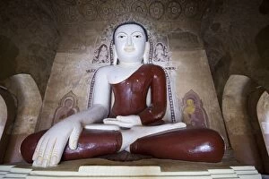 Sitting Buddha colored statue on a temple