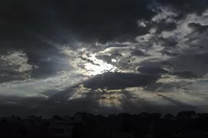 Sky with clouds and rays of sunshine, moody atmosphere