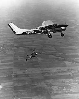 Grainy Prints: Skydiver jumping out of plane