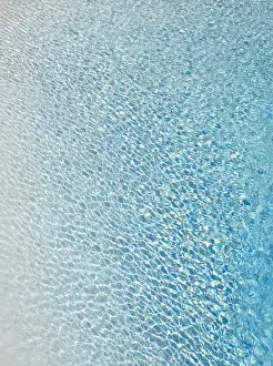 Light Reflex Prints: Slightly ruffled turquoise-coloured surface of water in a swimming pool