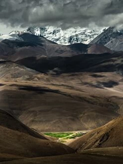 Small green valley within Tibetan mountain range