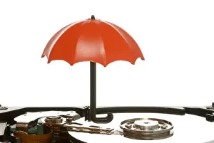 Electronic Prints: Small umbrella on a hard drive, symbolic image for data protection