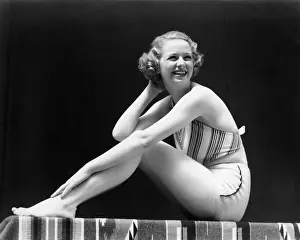 Suit Prints: Smiling Blonde Woman Wearing 2 Piece Bathing Suit Striped Halter Top Sitting Full Figure Profile Posing Pose Bench