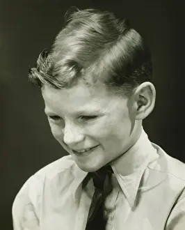 10 11 Years Prints: Smiling boy (10-11) posing in studio, (B&W), portrait