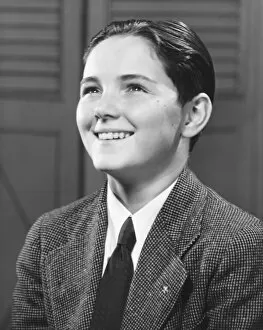 Smiling boy (12-13) posing, (B&W), close-up, portrait