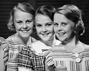 Only Girls Prints: Three smiling girls (12-13) in row, (B&W), portrait