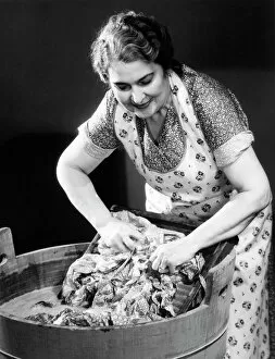 Retrofile Gallery: Smiling housewife doing laundry
