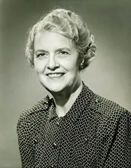 50 59 Years Prints: Smiling mature woman posing in studio, (B&W), portrait