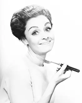Cutlery Prints: Smiling woman holding fork, (B&W), close-up
