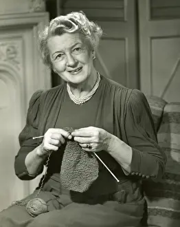 Smiling woman knitting