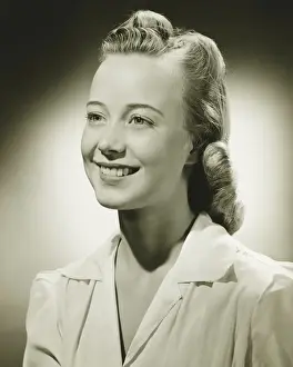Hair Style Prints: Smiling woman posing in studio, (B&W), portrait