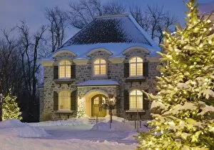 Snow covered cottage at dusk, Quebec, Canada