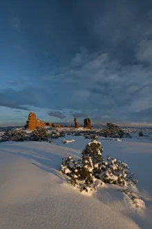 Dramatic Gallery: Snow covered landscape and reaching clouds near Balanced Rock, Arches National Park, Utah, USA