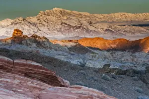 Snow covered mountains and different geological layers of rock, Valley of Fire State Park, Nevada, USA