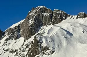 Snow-covered peaks of Le Brevent Mountain with the mountain station of the cable car