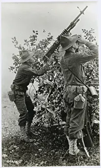 Soldier Aiming Antiaircraft Gun with Buddy Using Binoculars