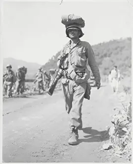 Soldier Carrying Equipment atop Head