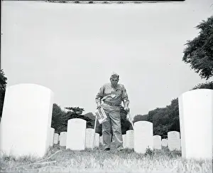 Headline Prints: Soldier In Cemetery With Newspaper