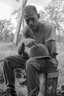 Soldier Displaying Bullet Hole in Helmet