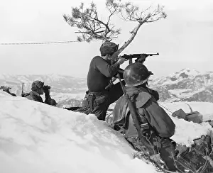 Soldier Fires Machine Gun on Snowy Hill