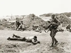 Guarding Prints: US Soldier Guarding Prisoners