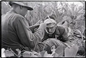 Soldier Helps Another Soldier with Bandage