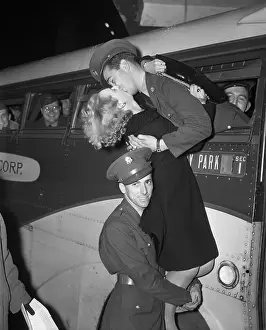 Soldier Holds Up A Girl To Kiss Soldier
