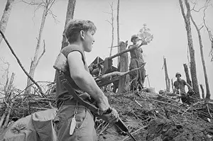 Soldier Looking Up at Soldier Holding Flower Bouquet