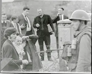 Soldier Pointing Bayonet at Father and Baby