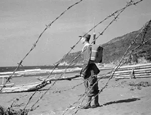 Soldier Standing Alone Near Fence