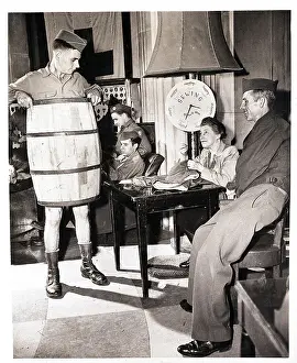 Sewing Prints: Soldier Wears Barrel while Woman Sews Pants