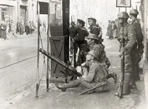 Crouching Prints: Soldiers Aiming Gun On City Street