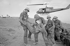 Soldiers Carrying Wounded To Helicopter