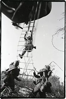 Soldiers Climbing Rope To Helicopter